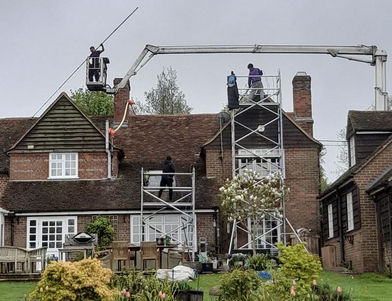 The Roof Moss Cleaners using cherry picker and scaffolding to clean roof safely and professionally in East Wittering, West Sussex