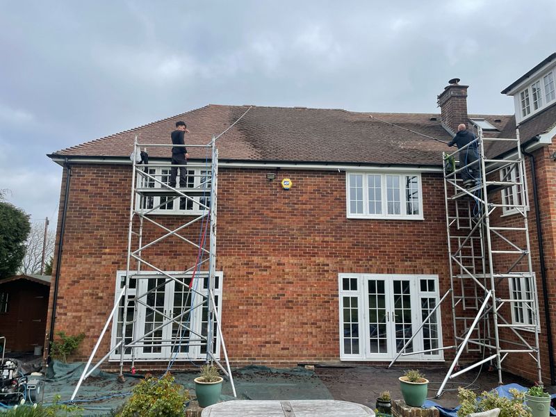 Roof cleaning carried out safely from scaffold towers by The Roof Moss Cleaners in East Wittering